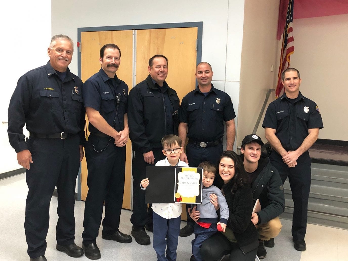 Our family with firefighters at our son’s school recognition assembly