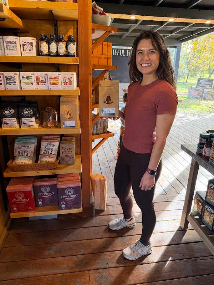 Marlette holding a bag of her coffee at Golden Door Country Store in San Marcos
