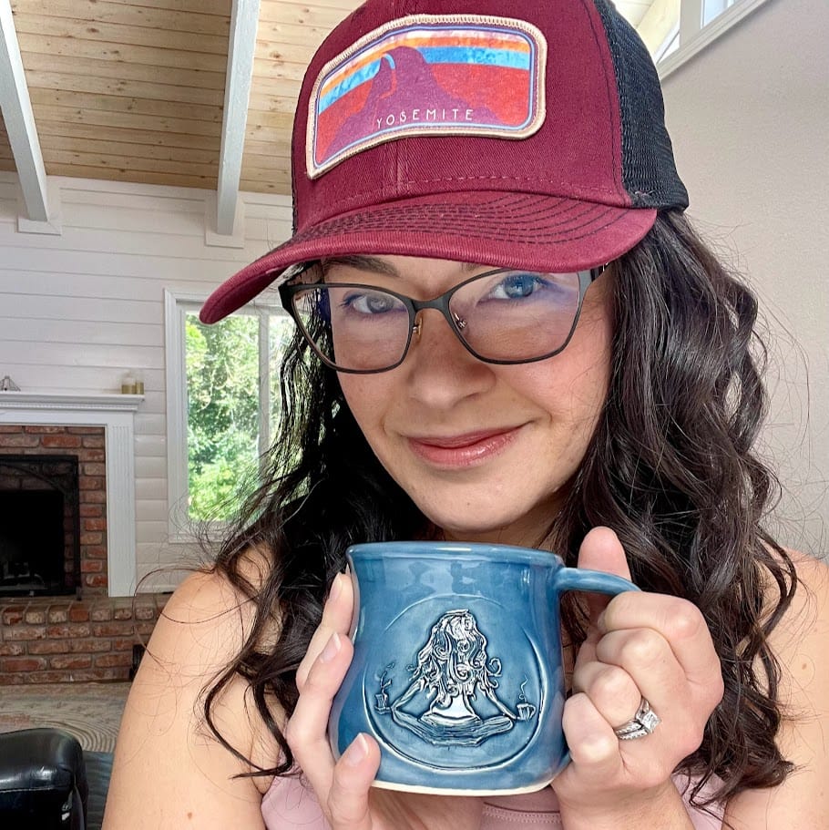 Marlette holding a blue Marlette’s Coffee mug